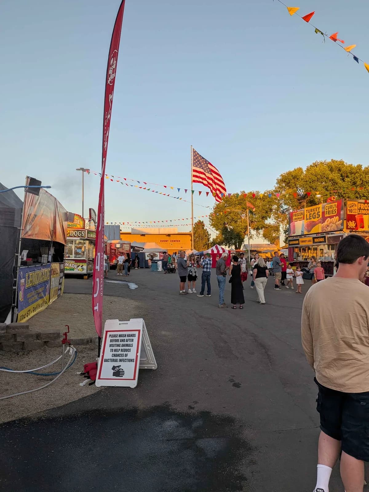 American flag, food vendors, and fairgrounds event center during the Klamath County Fair